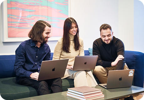 Neuron UX Team collaborating around laptops